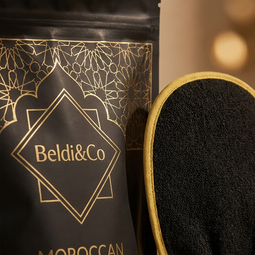 Close-up detail of Ghassoul Clay pouch and Kessa mitt for Clay Detox Ritual